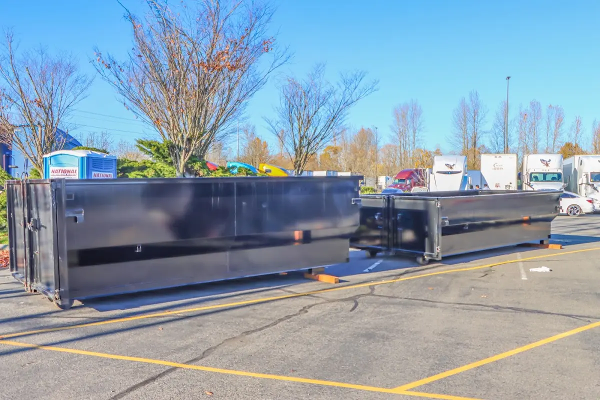 Professional dumpster rental service with roll-off container on residential driveway in Raymore
